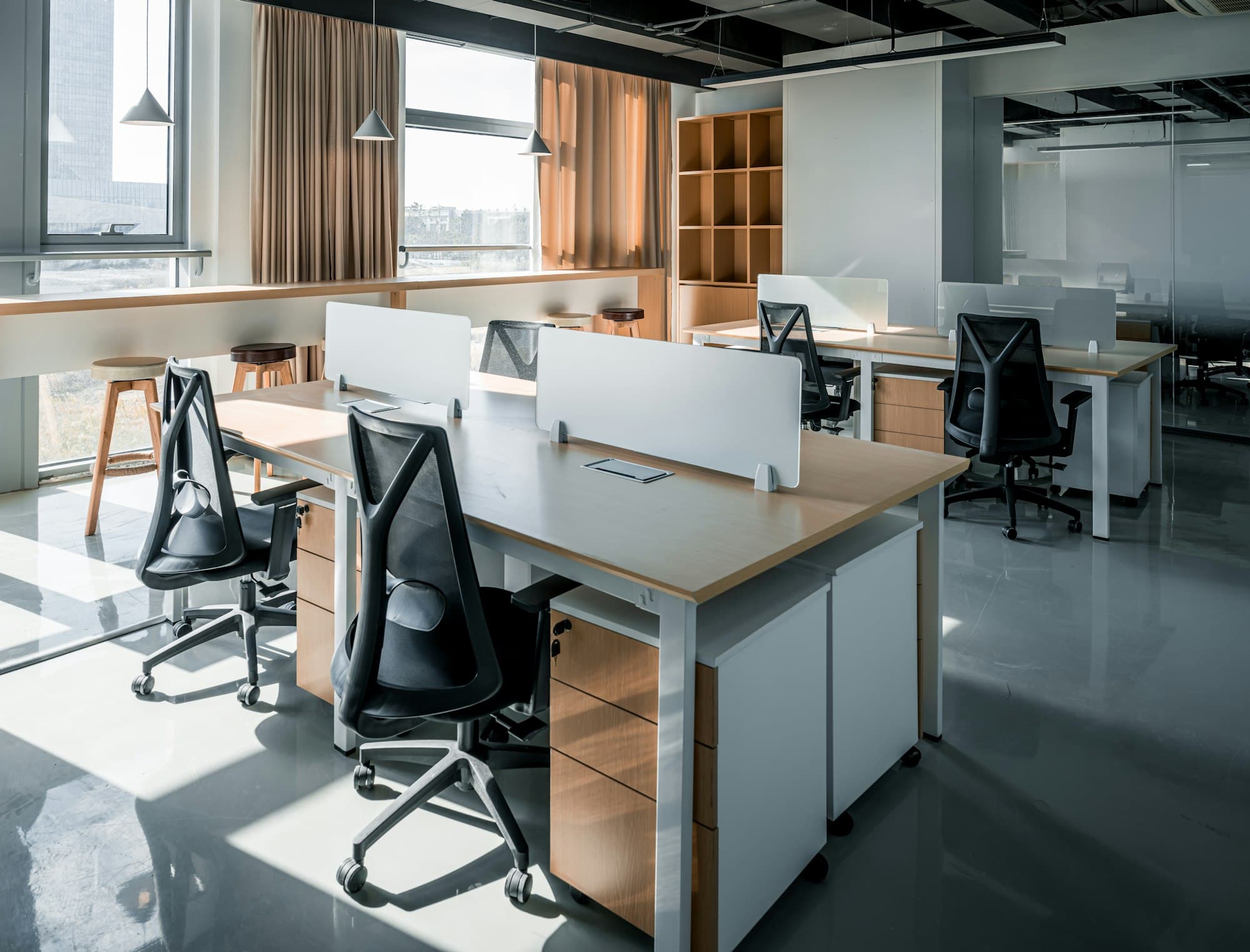 Open workspace with rows of desks and natural light